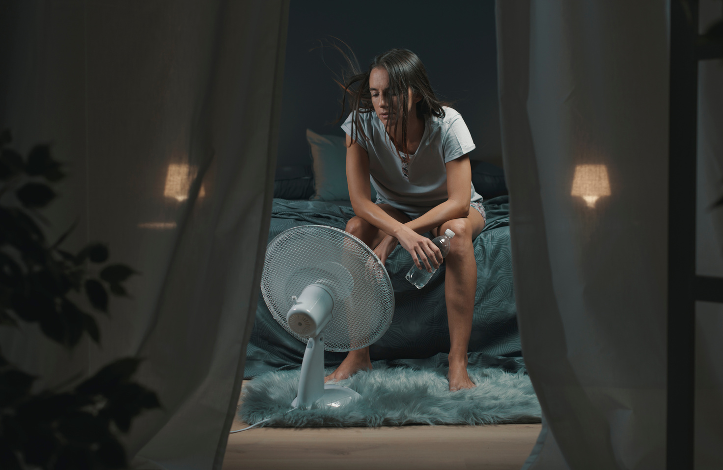 Woman in bedroom suffering during a heatwave