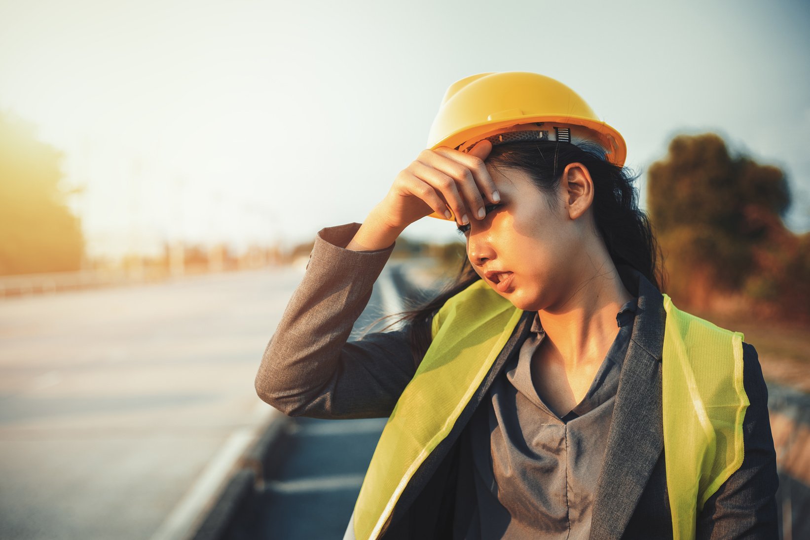 engineer women wipe sweat and hot weather at site construction.